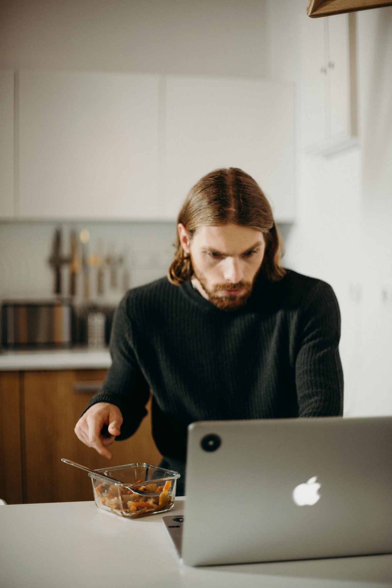 Person eating and tracking at laptop